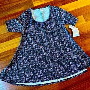 Woman’s XXS LuLaRoe purple patterned Perfect T with side slits.